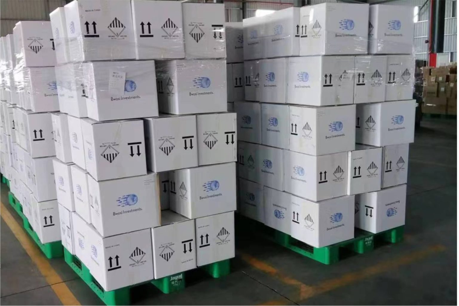 Pallets of Bwosi Investments cold chain shipping boxes in a warehouse