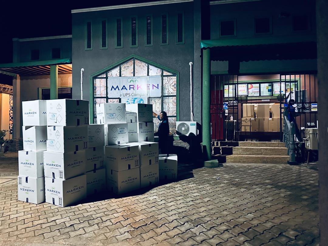 Marken branded boxes staged outside the Uganda distribution facility at night