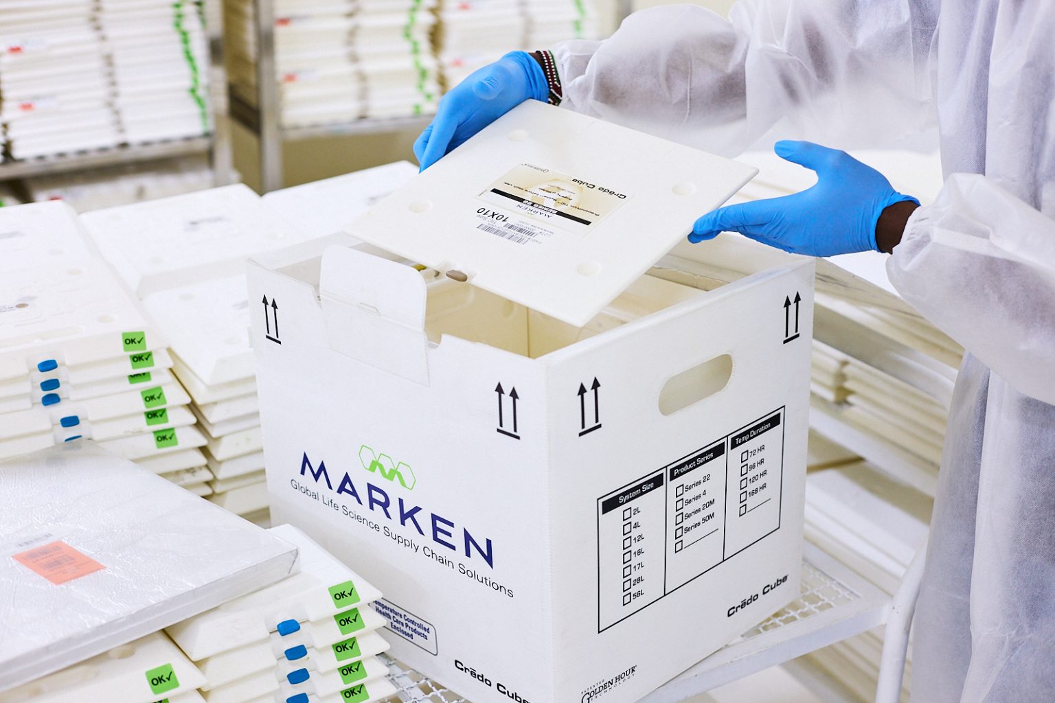 Technician packing a Marken Crédo Cube shipping box
